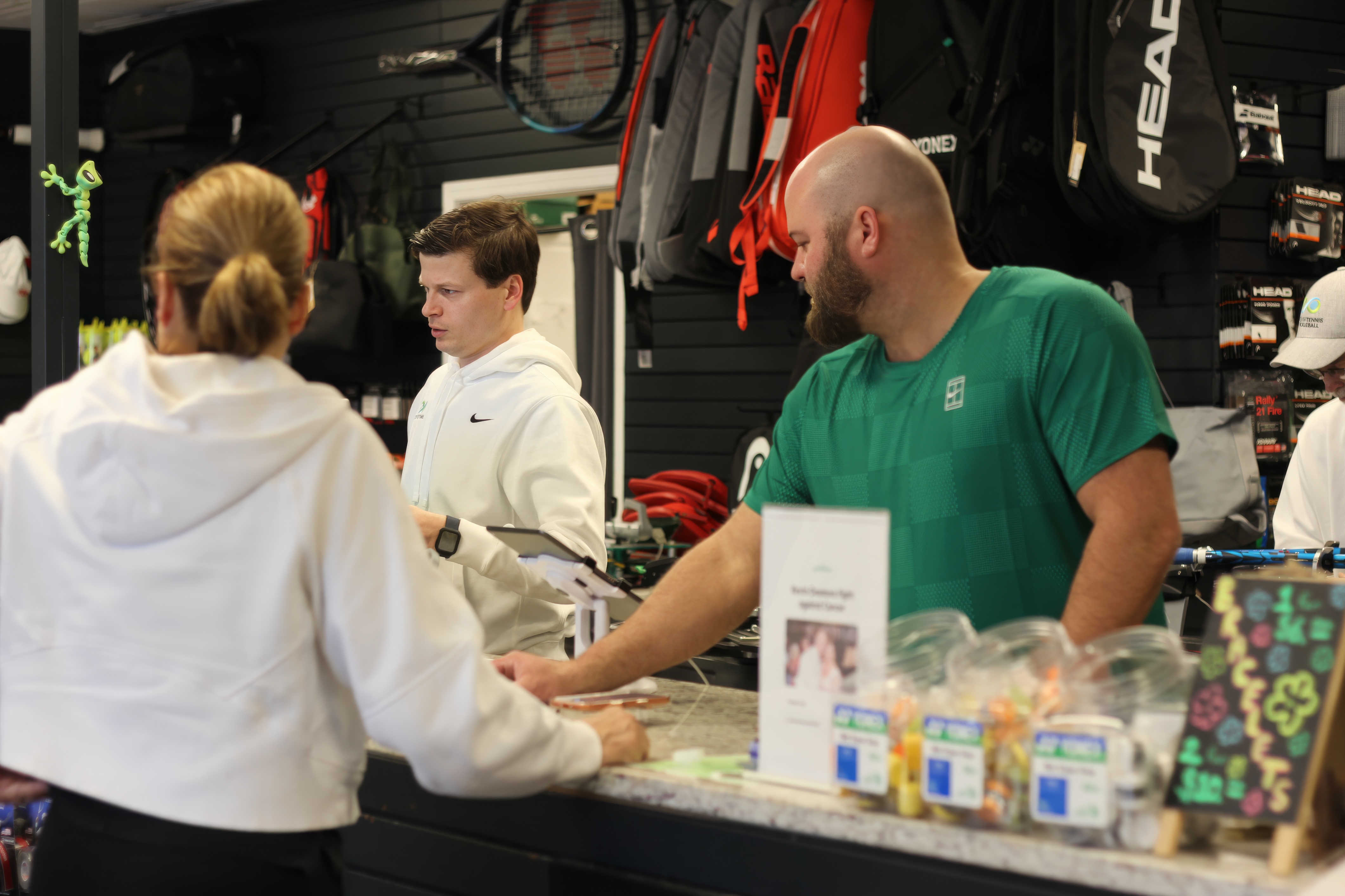 Staff helping a customer at Forever Tennis