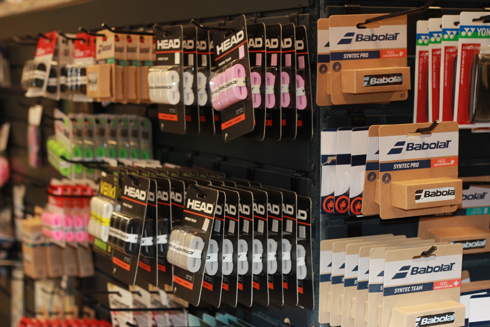 Wilson, Head, and Tourna overgrips on display at Forever Tennis.