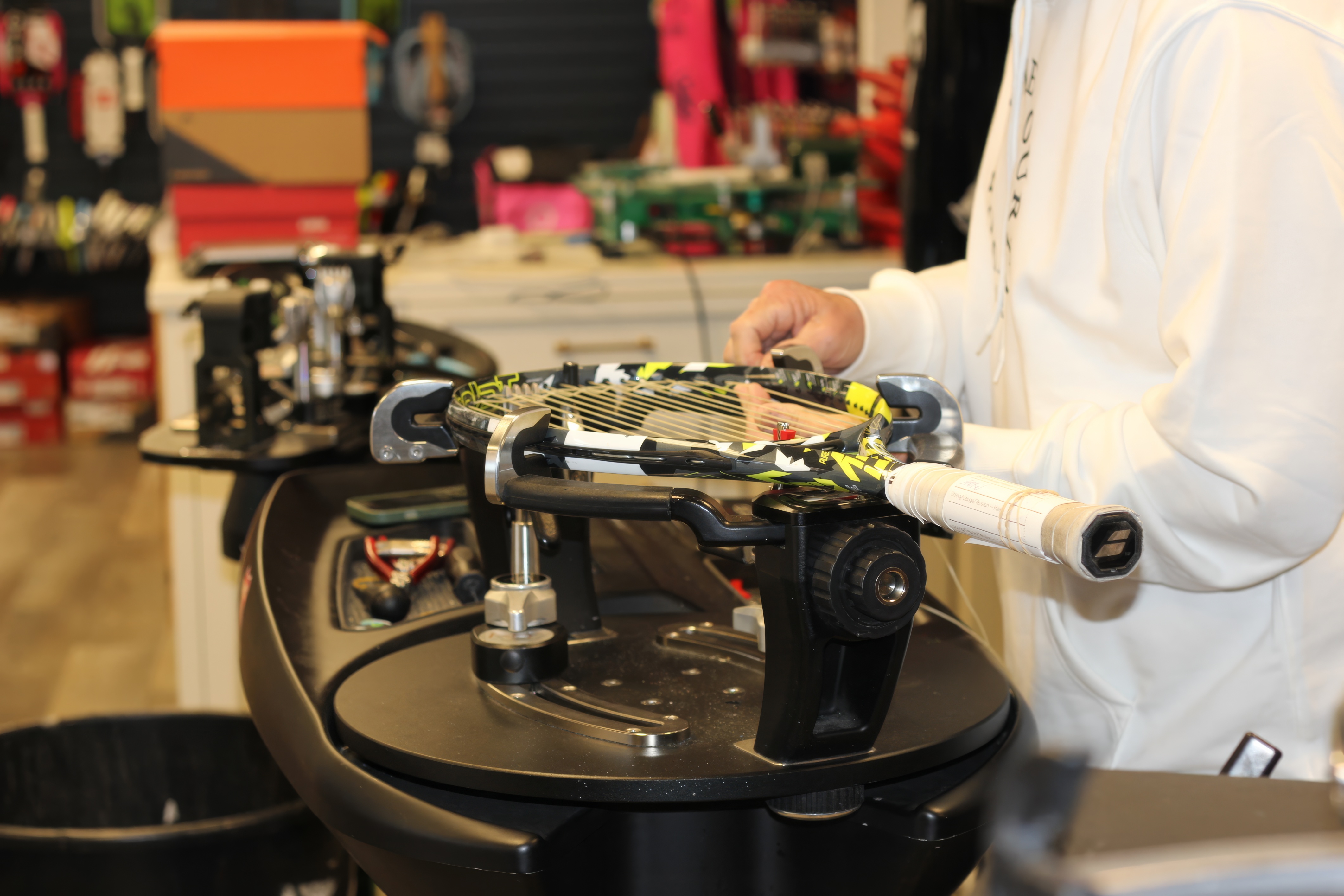 Close-up of racquet stringing at Forever Tennis